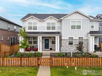 Charming two-story home with stone accents, covered porch, and a well-manicured lawn at 364 Fickel Farm Trl, Berthoud, CO 80513