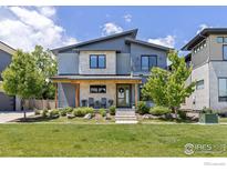 Beautiful two-story home with stone accents, a modern design, and a well-maintained front yard at 3681 Paonia St, Boulder, CO 80301