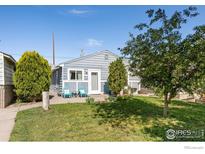 Charming single-story home with a well-maintained lawn and inviting blue Adirondack chairs on the front porch at 6743 King St, Denver, CO 80221