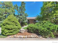 Charming single-story home with a brick facade and mature landscaping at 700 33Rd St, Boulder, CO 80303
