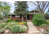 Charming single-story home with brick facade and mature landscaping at 1110 Hartford Dr, Boulder, CO 80305