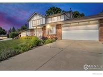 Charming two-story home with a well-maintained front yard and attached two-car garage at 11290 Ranch Pl, Denver, CO 80234