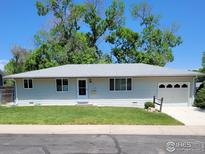 Charming single-story home with a well-maintained lawn and attached one-car garage at 1918 Sumac Pl, Longmont, CO 80501