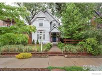 Charming two-story home with a beautifully landscaped front yard and inviting walkway at 2808 N Humboldt St, Denver, CO 80205