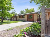Charming single-story home with a well-manicured lawn and mature trees in a peaceful neighborhood at 2901 Lorraine Ct, Boulder, CO 80304