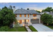 Elegant home boasts a manicured lawn, gray tile roof, and a convenient two-car garage at 315 Fairfax St, Denver, CO 80220