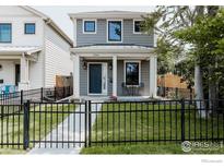 Charming two-story home featuring a welcoming front porch and well-maintained front yard at 3346 N Josephine St, Denver, CO 80205