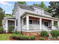 Charming home featuring a welcoming front porch with stone accents and a well-maintained landscaped yard at 3561 4Th St, Boulder, CO 80304