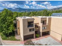 Beautiful exterior view with mountain backdrop and mature trees surrounding property at 3805 Northbrook Dr # A, Boulder, CO 80304