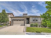 Charming ranch home with stone accents, well-manicured lawn, and solar panels at 4343 E 96Th Way, Thornton, CO 80229