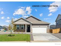 Charming one-story home featuring neutral siding, stone accents, and a well-manicured lawn at 4692 Hatcher Dr, Brighton, CO 80601