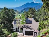 Stunning mountain views accentuate this home featuring solar panels and a two-car garage at 6310 Red Hill Rd, Boulder, CO 80302