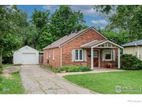 Charming brick home featuring a well-manicured lawn and detached one-car garage at 740 Hawthorn Ave, Boulder, CO 80304