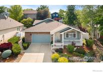 Charming one-story home with a brick facade and a well-manicured front yard at 742 Megan Ct, Longmont, CO 80504