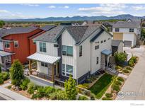 Charming two-story home with a landscaped yard, with mountain views in the background at 876 Cimarron Dr # B, Lafayette, CO 80026