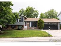 Charming home featuring a well-manicured front yard and an attached two-car garage at 15532 E Pacific Pl, Aurora, CO 80013