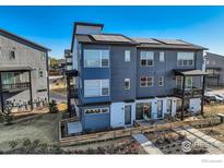 Beautiful townhome showing modern architecture, landscaping, and solar panels on the roof at 2446 W 167Th Ln, Broomfield, CO 80023