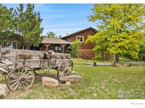 Ranch home with rustic wagon décor and landscaping in a rural setting at 2800 Lake Hollow Rd, Berthoud, CO 80513