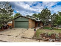 Charming brick home featuring an attached two-car garage and mature trees in a landscaped front yard at 3722 Monterey Pl, Boulder, CO 80301
