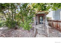 Charming home featuring stone accents, a covered porch, and mature trees at 3931 Osage St, Denver, CO 80211