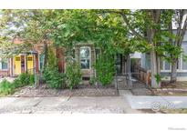 Charming home with stone accents and mature trees creating a private, inviting entrance at 3931 Osage St, Denver, CO 80211