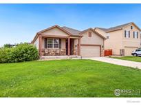 Charming single-story home featuring a well-manicured lawn and inviting front porch at 466 Freestone St, Brighton, CO 80603