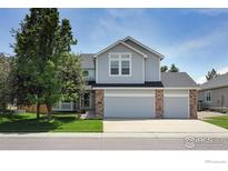 Charming two-story home featuring a spacious three-car garage, manicured lawn, and beautiful landscaping at 5603 Pierson Mountain Ave, Longmont, CO 80503