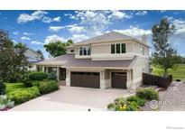 Beautiful two-story home featuring a three-car garage and lush landscaping with mature trees at 5695 Aurora Pl, Boulder, CO 80303