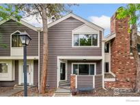 Charming townhome featuring a brick chimney and a cozy front porch with ample natural light at 6710 W 84Th Way # 19, Arvada, CO 80003
