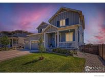 Charming two-story home with inviting porch, landscaped yard, and a three car garage at 10 N Quantock St, Aurora, CO 80018