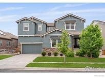 Charming two-story home with stone accents, well-kept landscaping and a two car garage at 15998 Humboldt Peak Dr, Broomfield, CO 80023