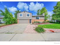 Charming two-story home with a well-manicured lawn and a two car garage at 2113 Spencer St, Longmont, CO 80501