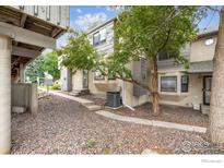 Charming townhouse featuring neutral stucco siding, a well-maintained landscape, and inviting curb appeal at 2249 Emery St # B, Longmont, CO 80501