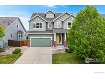 Charming two-story home boasts a well-maintained yard, two car garage, and inviting front porch at 3717 Desert Ridge Cir, Castle Rock, CO 80108