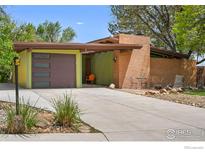 Charming mid-century modern home with well-maintained yard and eye-catching exterior at 5450 Mohawk Rd, Littleton, CO 80123