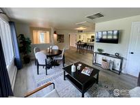 Inviting living room with open-concept design, wood flooring, modern décor, and plenty of natural light at 800 Mohawk Dr, Boulder, CO 80303