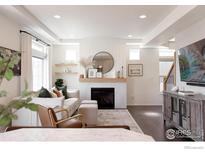 Bright living room featuring a fireplace, modern decor, and dark hardwood floors at 970 Auburn Dr, Erie, CO 80516