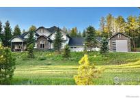 Charming two-story home with a landscaped yard and a stone and siding exterior at 10525 Wild Fox Pl, Franktown, CO 80116
