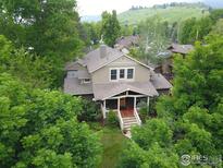 Charming home nestled in lush greenery, featuring a welcoming front porch and classic architectural details at 1816 Mariposa Ave, Boulder, CO 80302