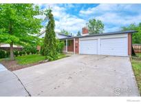 Charming brick home with a two-car garage and a well-maintained front yard at 1868 Princess Dr, Longmont, CO 80501