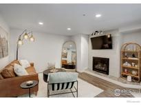 Cozy living room features a fireplace, television, and modern furniture at 2802 Sundown Ln # 210, Boulder, CO 80303