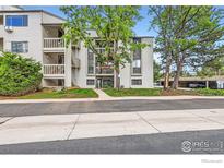 Condo building featuring private balconies, mature trees, and well-maintained landscaping at 3515 28Th St # 108, Boulder, CO 80301