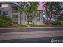 Condo building featuring private balconies, mature trees, and well-maintained landscaping at 3515 28Th St # 108, Boulder, CO 80301