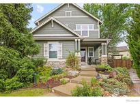 Charming two-story home featuring manicured landscaping, a stone foundation, and a welcoming front porch at 4219 Frederick Cir, Longmont, CO 80503