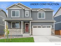 Charming two-story home with a covered front porch and a two car garage at 4730 Hatcher Dr, Brighton, CO 80601