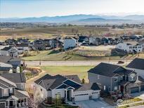 An inviting community with mountain views, lush green spaces, and well-maintained homes evokes serene suburban living at 675 Lene Ln, Berthoud, CO 80513