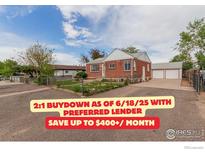 Charming brick home with a detached two-car garage and a well-maintained yard and long driveway at 8110 Ivy St, Commerce City, CO 80022