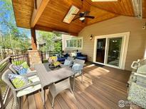 Outdoor deck featuring a dining set, lounge seating, ceiling fan, skylights, and a built-in grill at 1069 Monarch Way, Superior, CO 80027