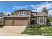 Charming two-story home with manicured lawn, brick accents and three car garage at 1069 Monarch Way, Superior, CO 80027