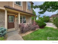 Charming home with a brick and siding exterior, featuring a covered porch and well-maintained landscaping at 118 Pheasant Run, Louisville, CO 80027